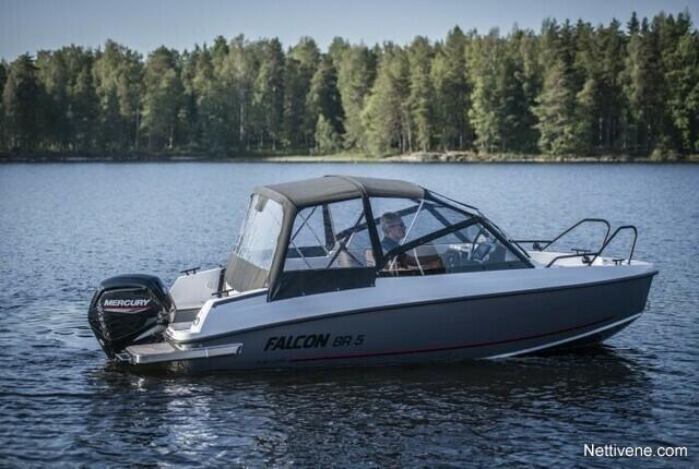 A Falcon BR 5 boat with a Mercury motor glides on calm water, surrounded by lush green trees.
